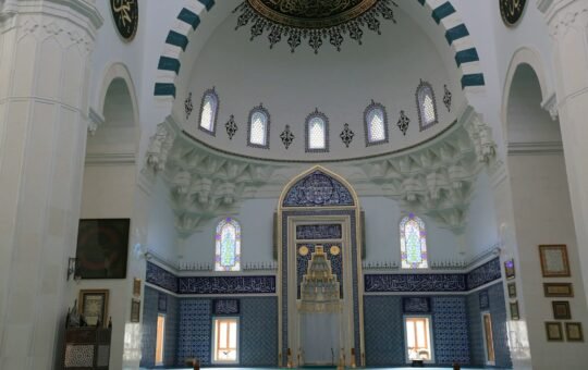 Interior of a grand mosque with a large dome