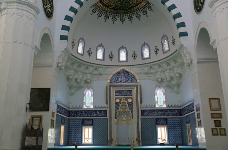Interior of a grand mosque with a large dome